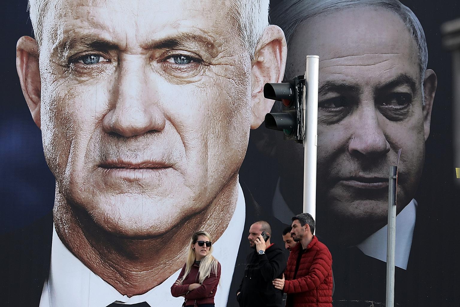 The Blue and White alliance's election banner, which depicts its leader Benny Gantz and Israeli Prime Minister Benjamin Netanyahu, in Tel Aviv last week. Both the Blue and White and Mr Netanyahu's Likud have been projected to fall short of forming a