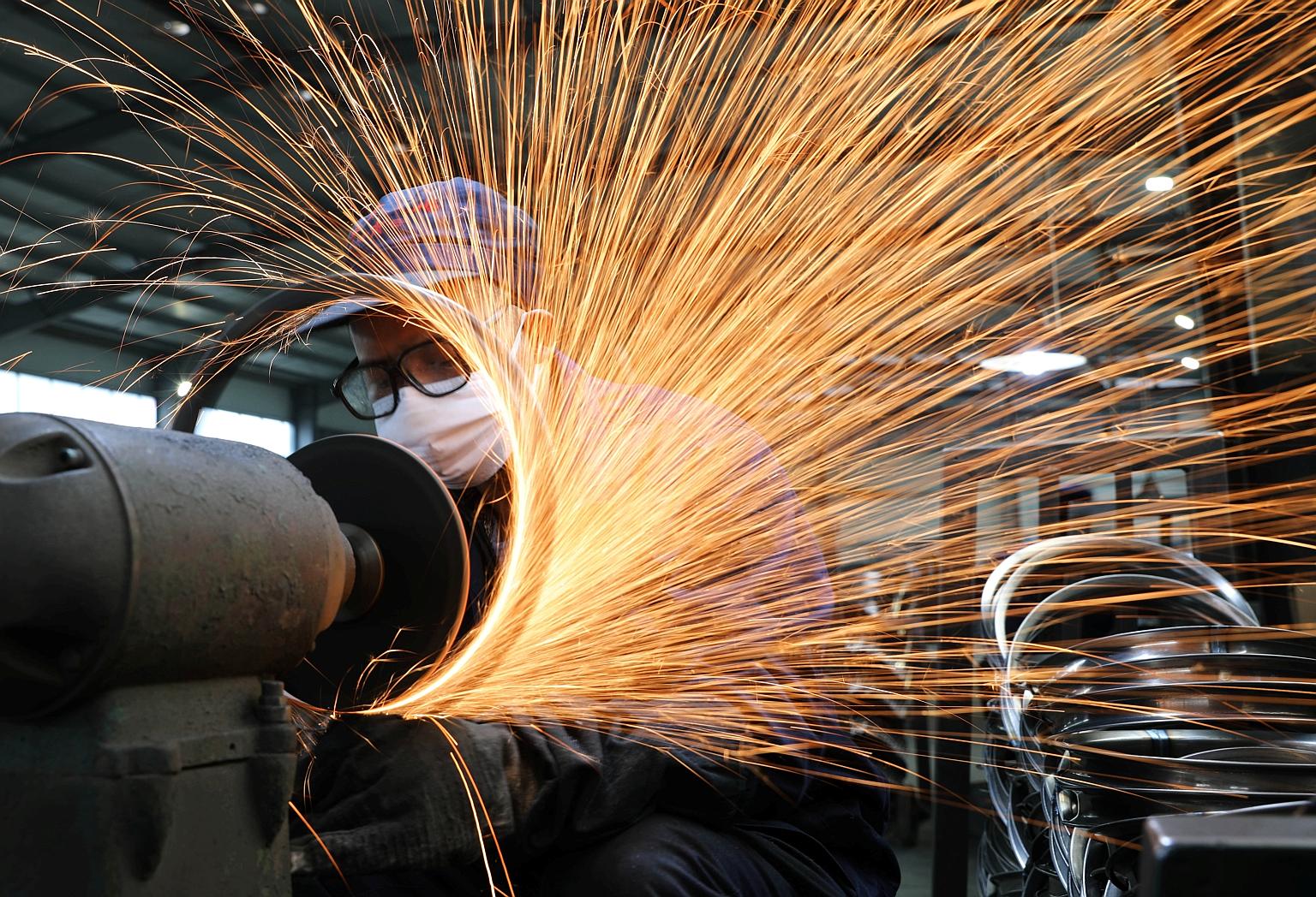 A worker helping to manufacture bicycle steel rims in a factory in Hangzhou in China's Zhejiang province. The slump in factory activity in China and other Asian economies has bolstered speculation that global policymakers will launch a coordinated re