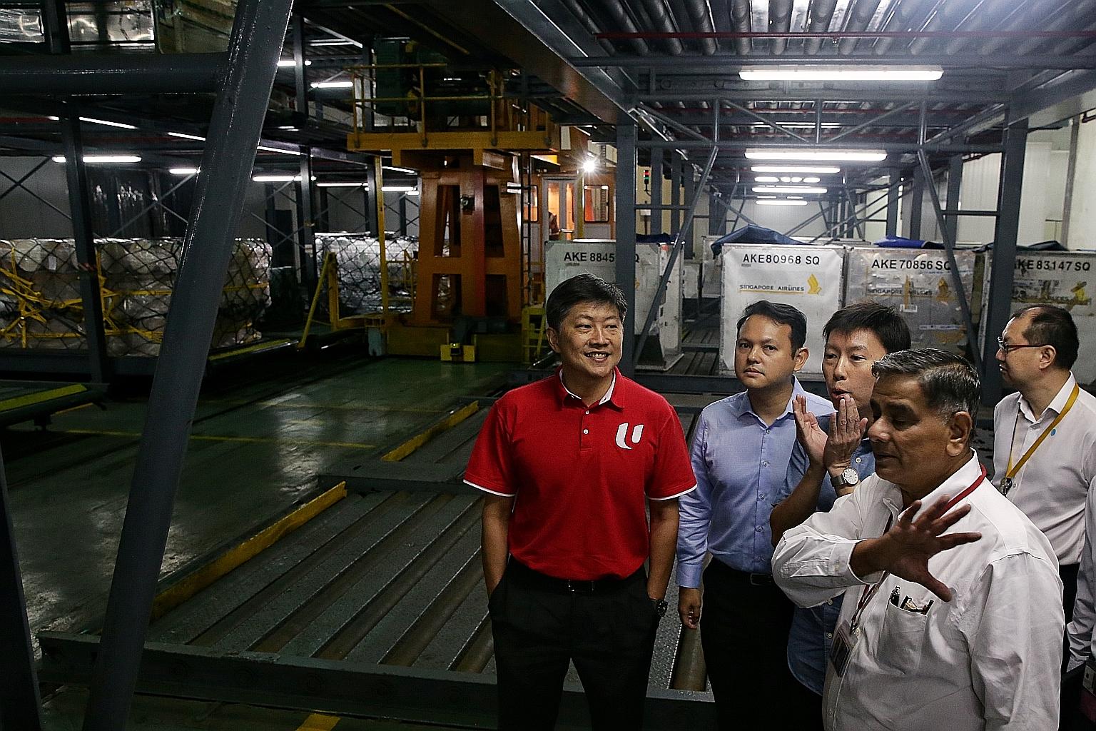 (From left) Labour chief Ng Chee Meng, Minister of State for Manpower and National Development Zaqy Mohamad and Senior Minister of State for Trade and Industry and Education Chee Hong Tat being taken on a tour of a Sats facility by Sats Gateway Servi