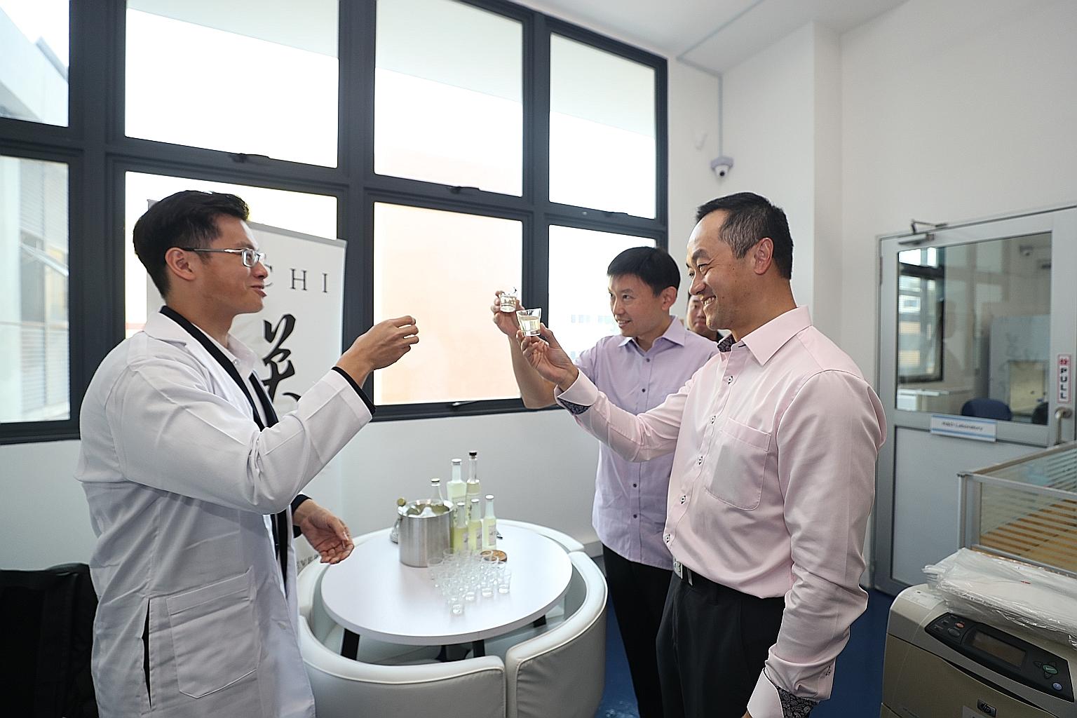 (From left) SinFooTech chief executive Jonathan Ng and Senior Ministers of State for Trade and Industry Chee Hong Tat and Koh Poh Koon trying out Sachi - an alcoholic beverage fermented from soya whey, a by-product of tofu that is currently disposed