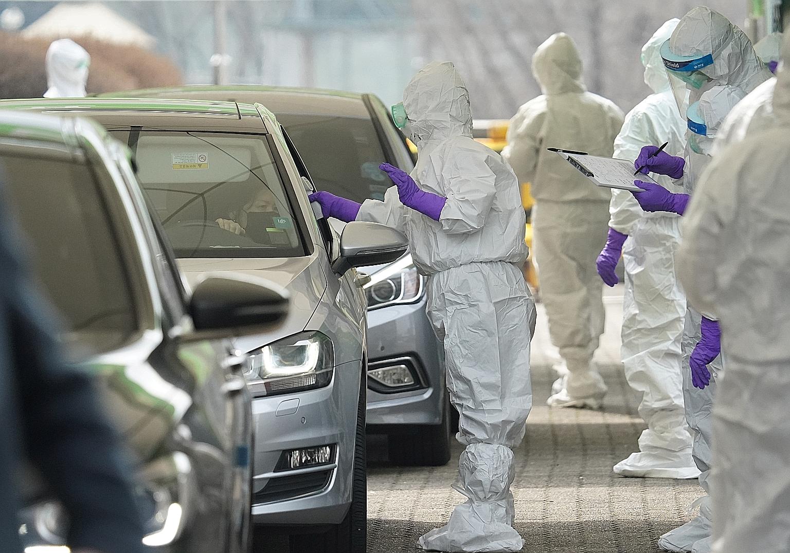 A driver getting a coronavirus test done at a drive-through clinic in Seoul yesterday. With the latest ban on visitors, Singaporeans, residents and long-term pass holders who have been to the affected Covid-19-hit areas in the past 14 days will be al