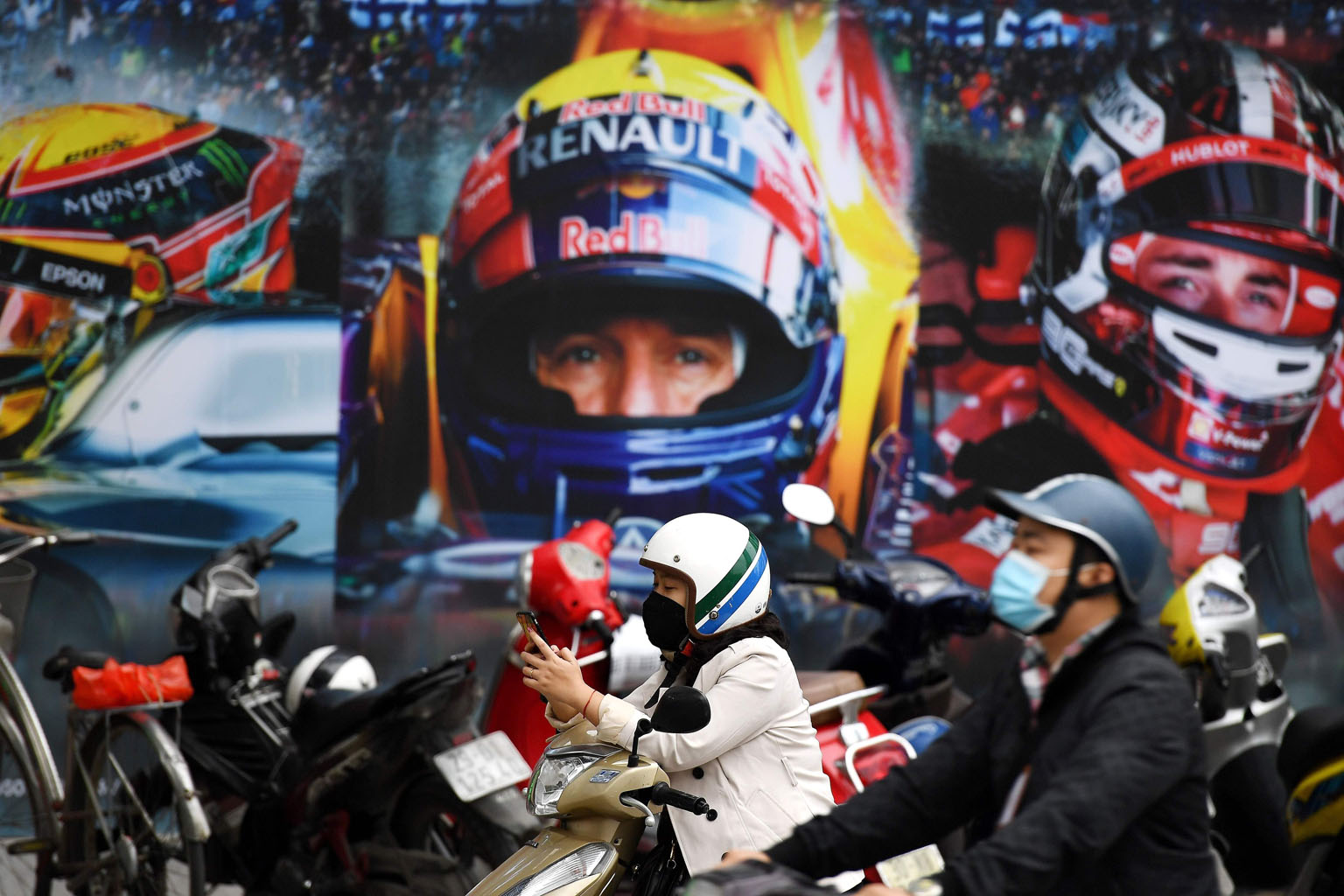 Motorcyclists wearing masks outside the Formula One Vietnam Grand Prix merchandise store in Hanoi. The Vietnamese capital will host its first F1 race on April 5 amid the coronavirus outbreak. PHOTO: AGENCE FRANCE-PRESSE