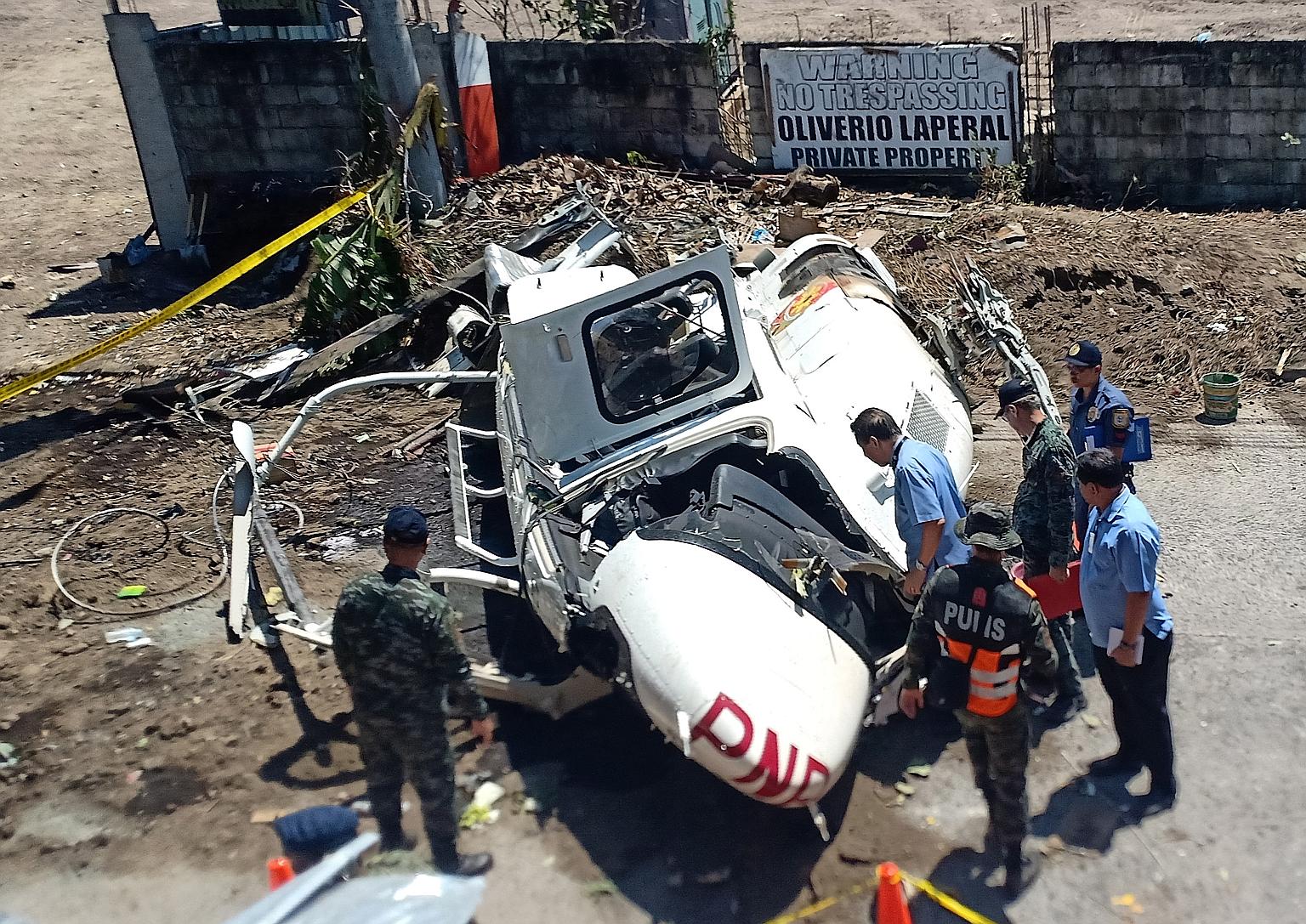The wreckage of the Bell 429 helicopter that was carrying top Philippine police official Archie Gamboa (above) and his aides yesterday. He had just finished inspecting a police compound where cars were impounded in San Pedro city, Laguna province, an