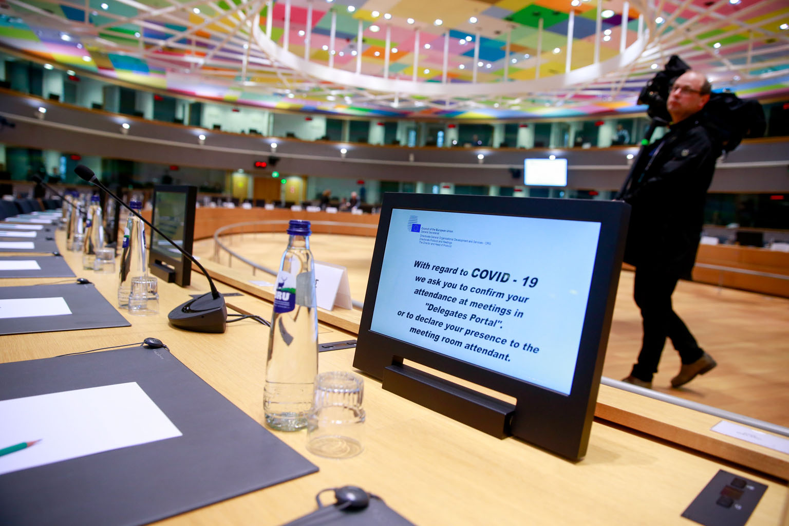 A security message on the coronavirus displayed on a screen at the start of a meeting on Wednesday on the Syrian conflict at the European Council, where a staff member has been confirmed to have the virus. Talks between health ministers are set to go