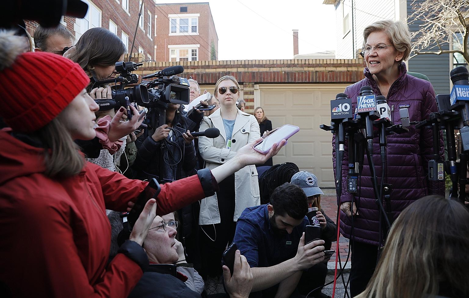 US Senator Elizabeth Warren speaking to reporters outside her home in Cambridge, Massachusetts, on Thursday after dropping out of the Democratic presidential race. The progressive lawmaker said she "will stay in the fight for the hardworking folks ac