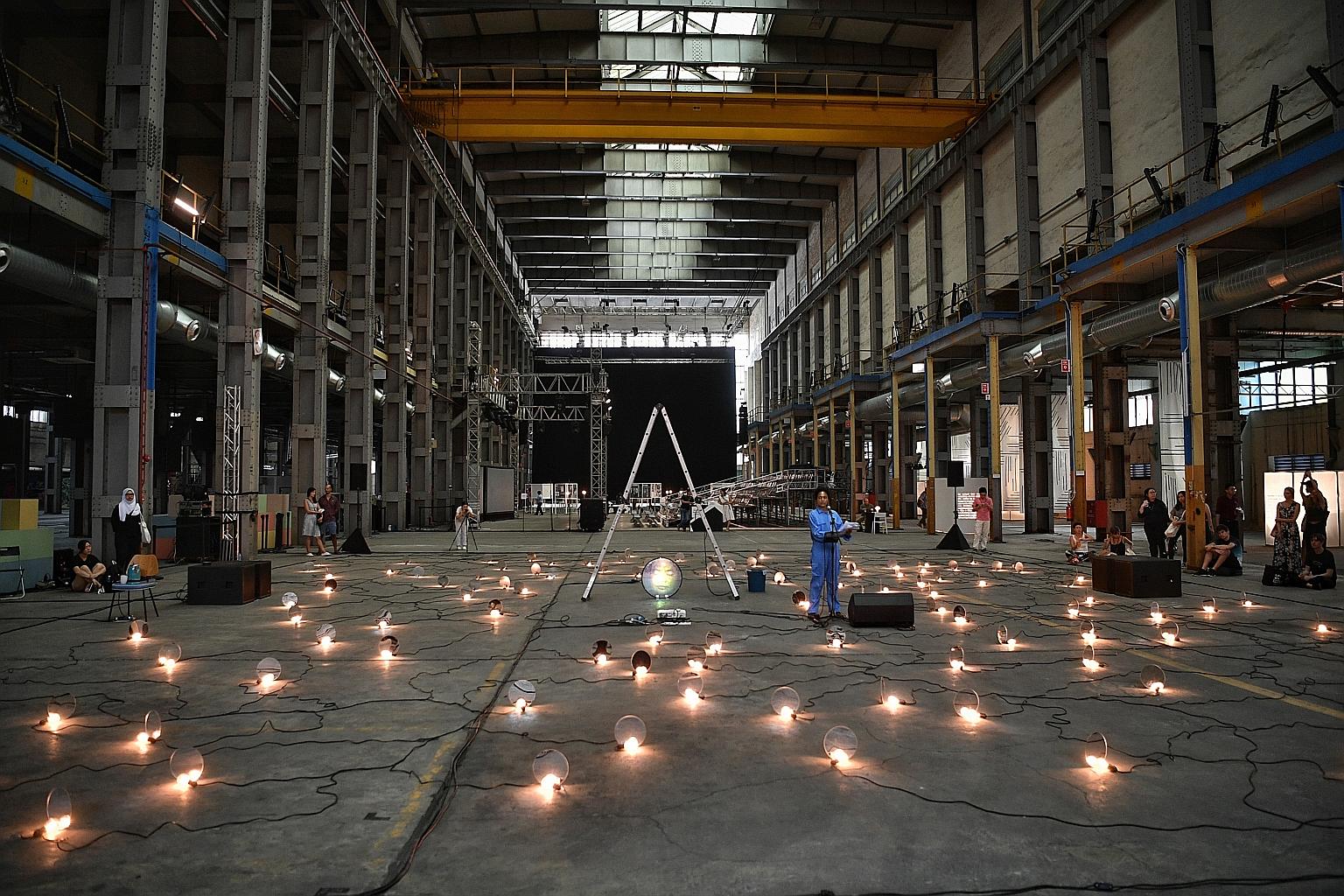 Spoken-word poet Deborah Emmanuel at the decommissioned Pasir Panjang Power Station yesterday, telling the stories of people who had worked at the plant, as part of a work she co-created with visual artist Alecia Neo and sound artist Li-Chuan Chong.