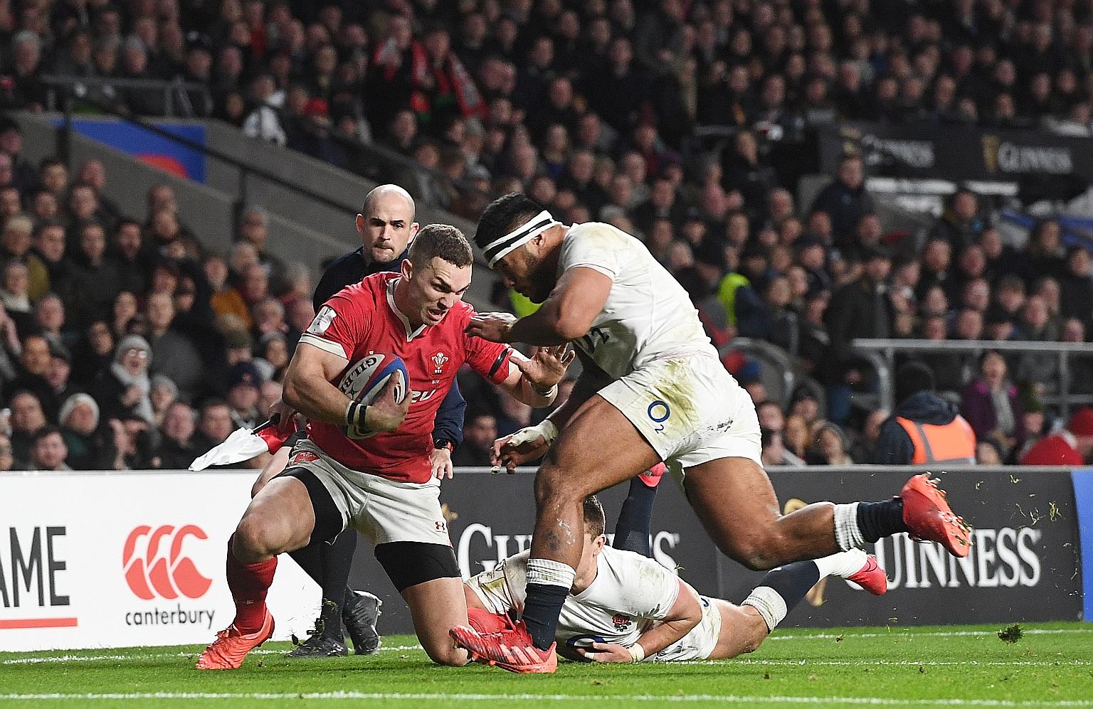 England's Manu Tuilagi (right) was sent off for an illegal no-arms tackle on Wales' George North (left) during the Six Nations match. 