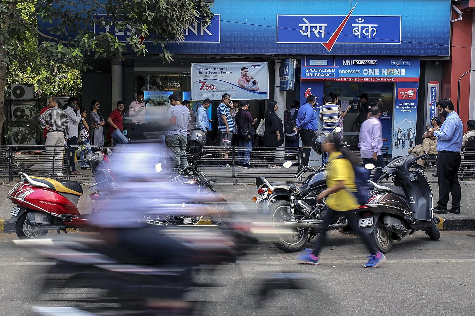 Customers standing in line outside a Yes Bank branch in Mumbai, India, last Friday. The Reserve Bank of India took to Twitter on Sunday to affirm the safety of deposits in the wake of a decision to seize Yes Bank and invite the nation's largest lende