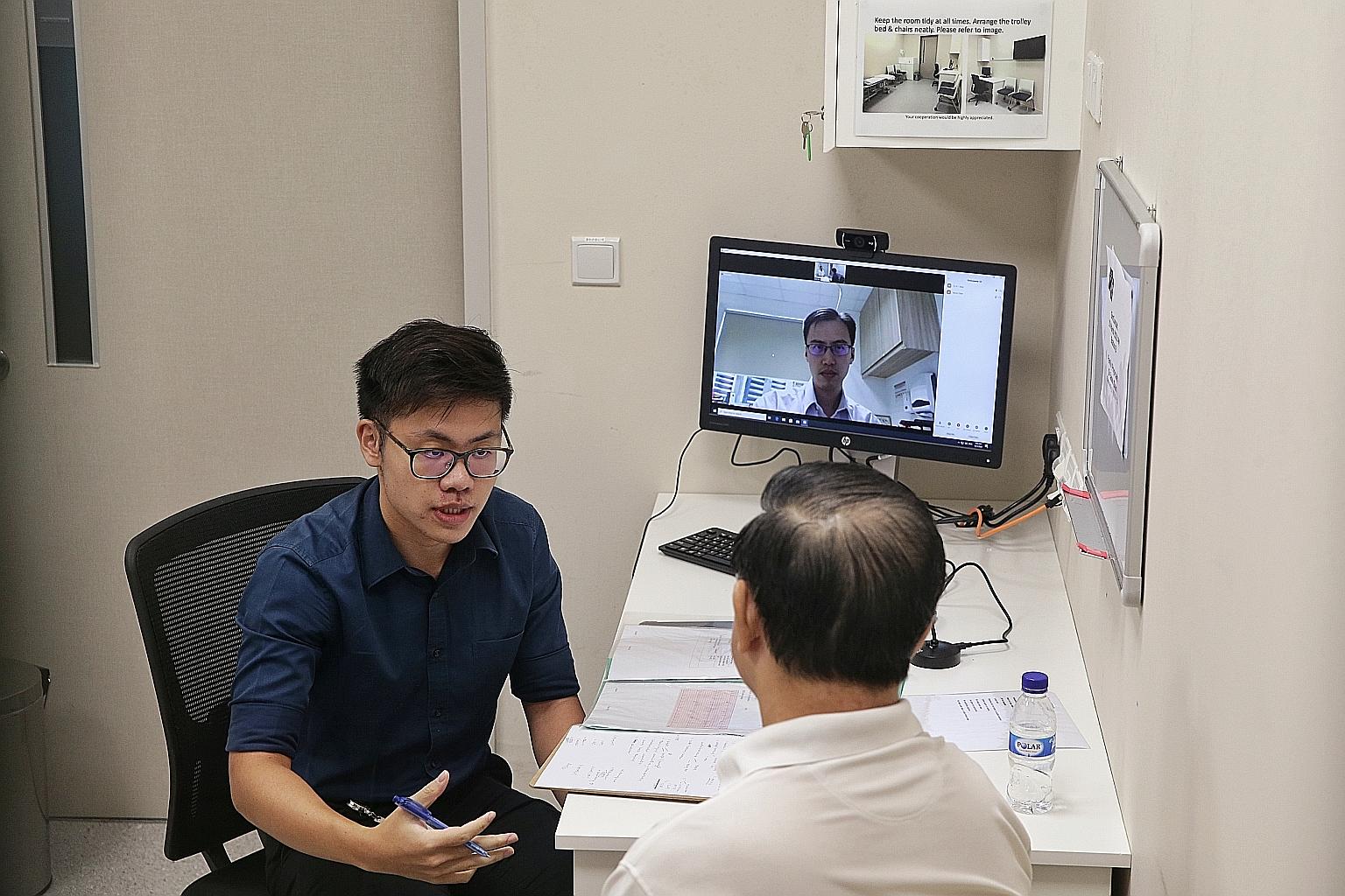 Lee Kong Chian School of Medicine Year 5 student Stanley Low talking to a patient-actor during a simulated consultation yesterday.