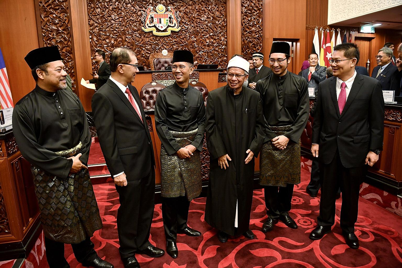 Datuk Seri Hishammuddin Hussein (left) receiving documents from the Malaysian King, Sultan Abdullah Ri'ayatuddin, before taking the oath as foreign minister at the Istana Melawati in Putrajaya. PHOTO: AGENCE FRANCE-PRESSE