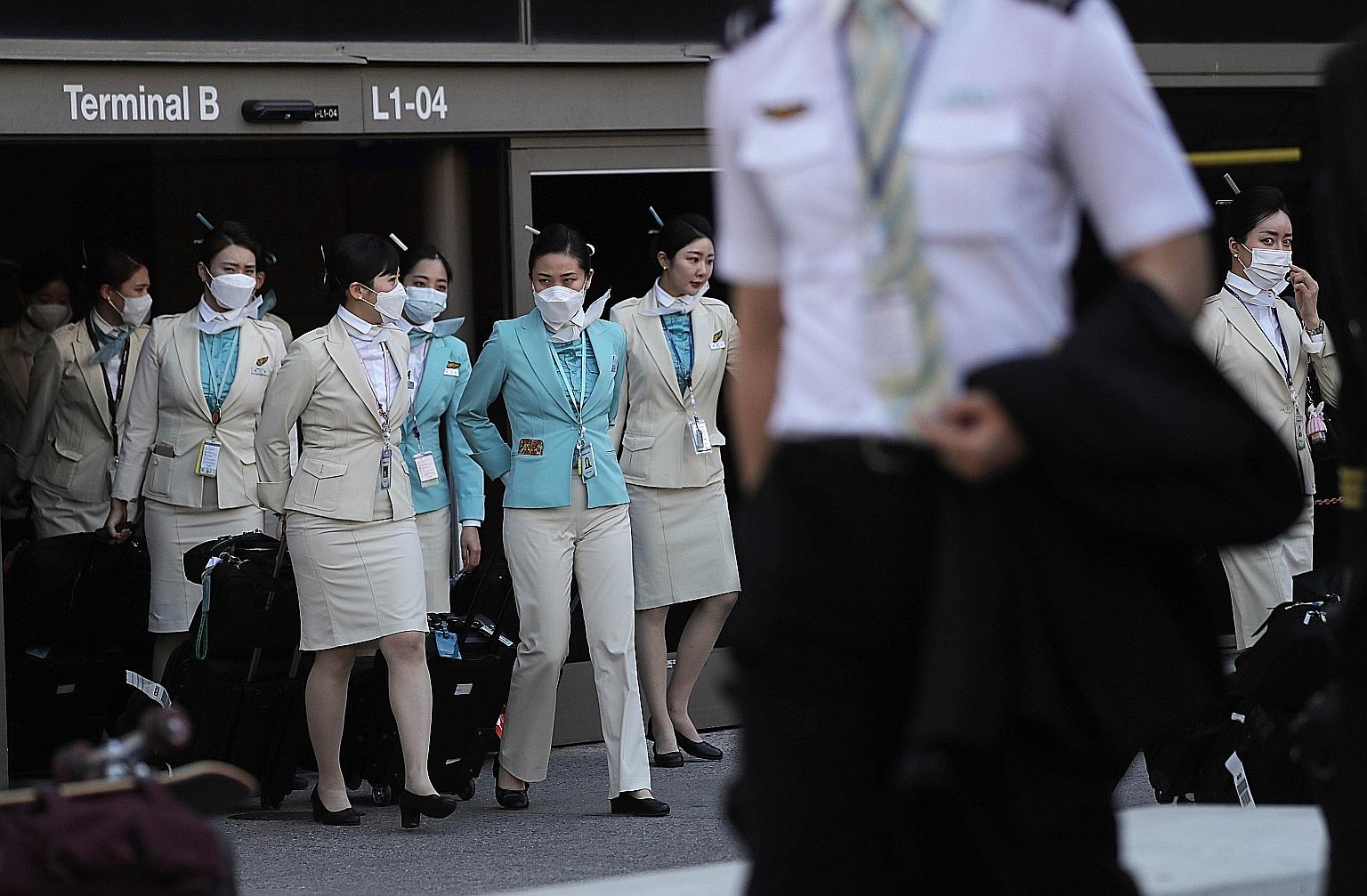 A Korean Air crew departing the international terminal after arriving at Los Angeles International Airport last month. The global airline industry has been among the sectors hardest hit by the coronavirus outbreak, losing almost a third of its value 