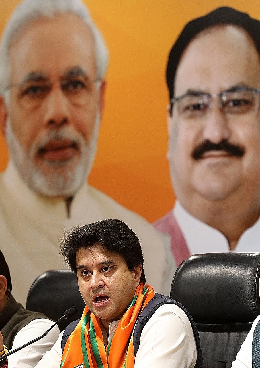 Former senior Congress leader Jyotiraditya Scindia speaking to reporters at the Bharatiya Janata Party office in New Delhi yesterday. Mr Scindia is said to have been unhappy over not being chosen as Madhya Pradesh chief minister by the Congress party