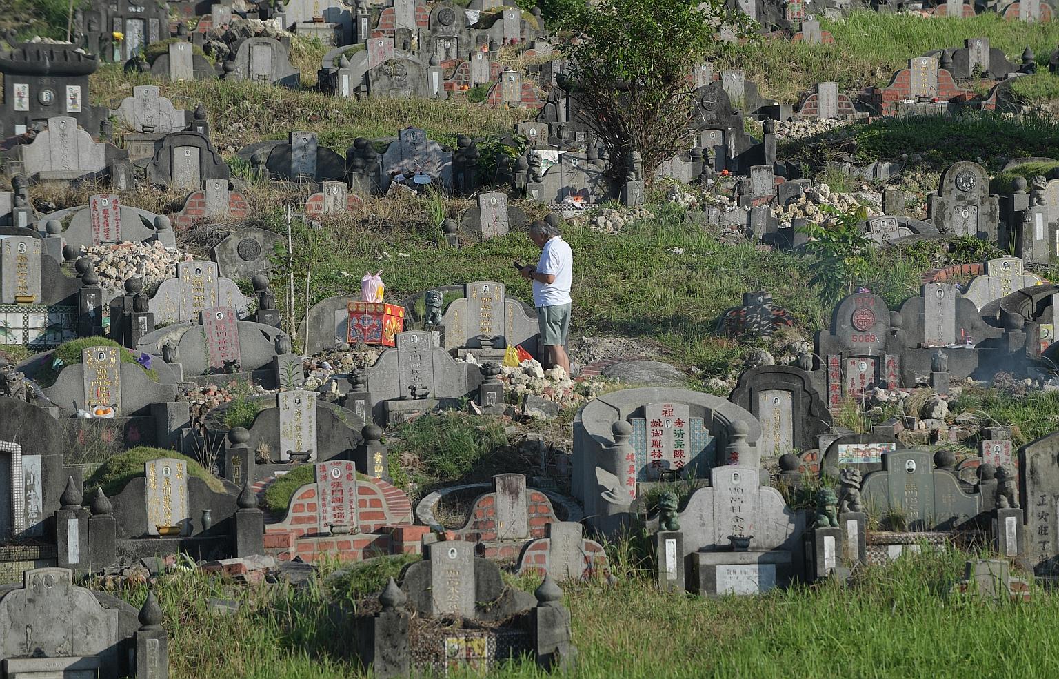 A man with offerings at Choa Chu Kang Chinese Cemetery during the Qing Ming Festival in April last year. This year's festival will take place on April 4, and those who are sick are reminded to avoid visiting the cemeteries and columbaria. NEA has als