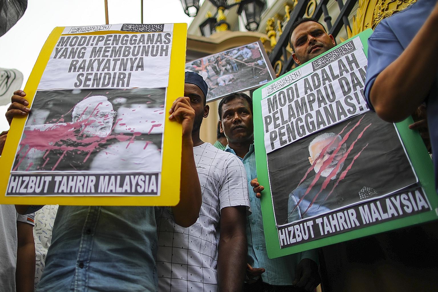 Demonstrators with placards calling for an end to violence against the Muslim community in India, outside India's High Commission in Kuala Lumpur, Malaysia, last week. Large parts of India's capital New Delhi erupted in violence between Hindus and Mu
