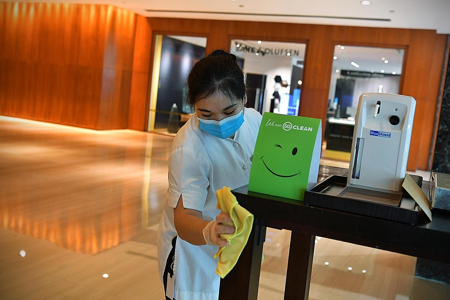 A cleaner wiping surfaces yesterday in the lobby of Grand Hyatt Singapore, which was declared an inactive cluster earlier this week. Over 37,000 businesses in the tourism and lifestyle sectors will be encouraged to get certified in the coming months.