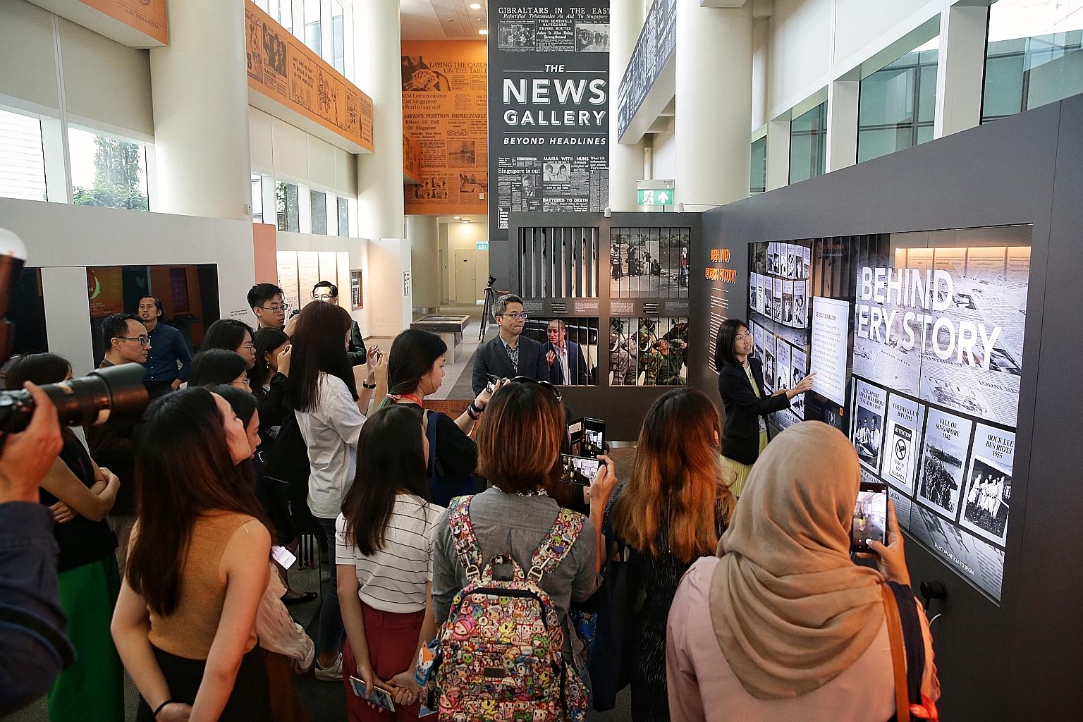 Invited guests touring the National Library's new permanent exhibition, The News Gallery: Beyond Headlines, yesterday. ST PHOTO: KEVIN LIM