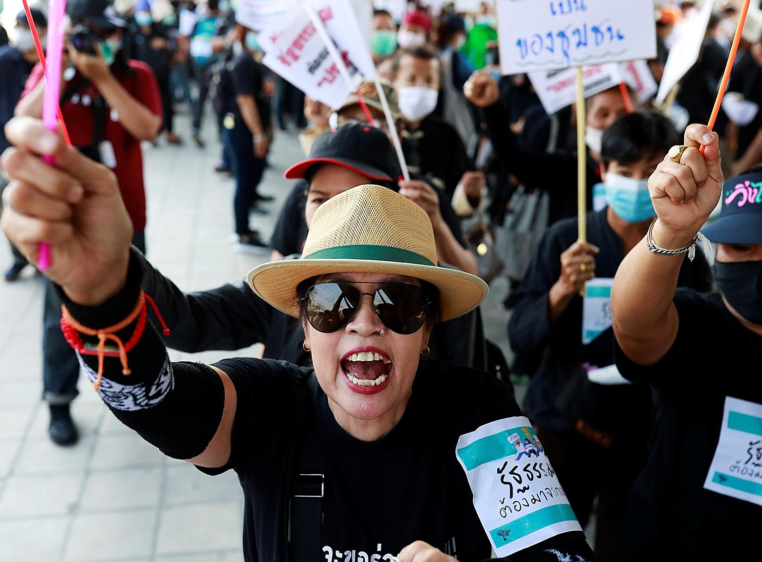 Protesters marching on Parliament in Bangkok yesterday. Discontent with Thailand's administration is seething, with a progressive opposition party, the Future Forward Party, disbanded and the country's economy faltering as the coronavirus crisis batt