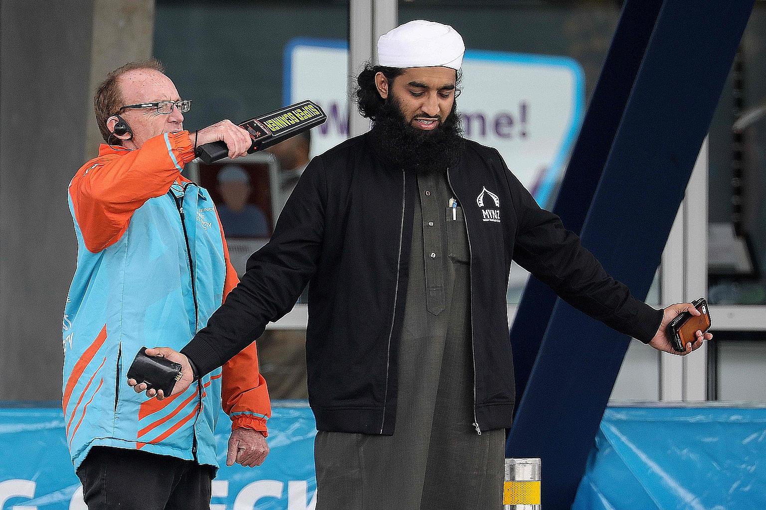 Worshippers from the Al Noor mosque arriving for Friday prayers (above) ahead of the one-year anniversary of the mosque attacks in Christchurch, New Zealand. A security officer scanning a member of the Muslim community (below) ahead of prayers at Hor
