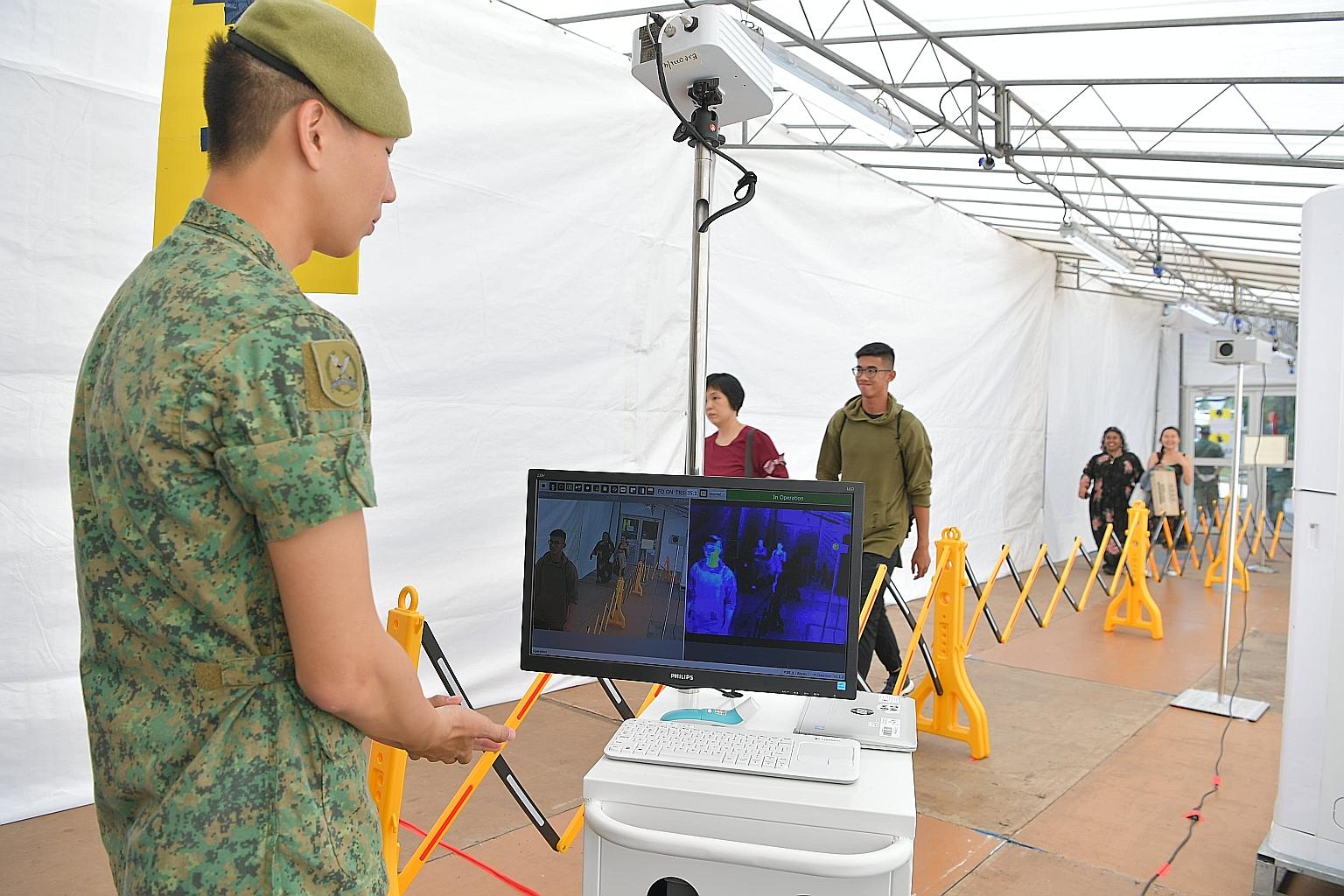 Parade attendees at the Safti Military Institute undergoing temperature screening yesterday.