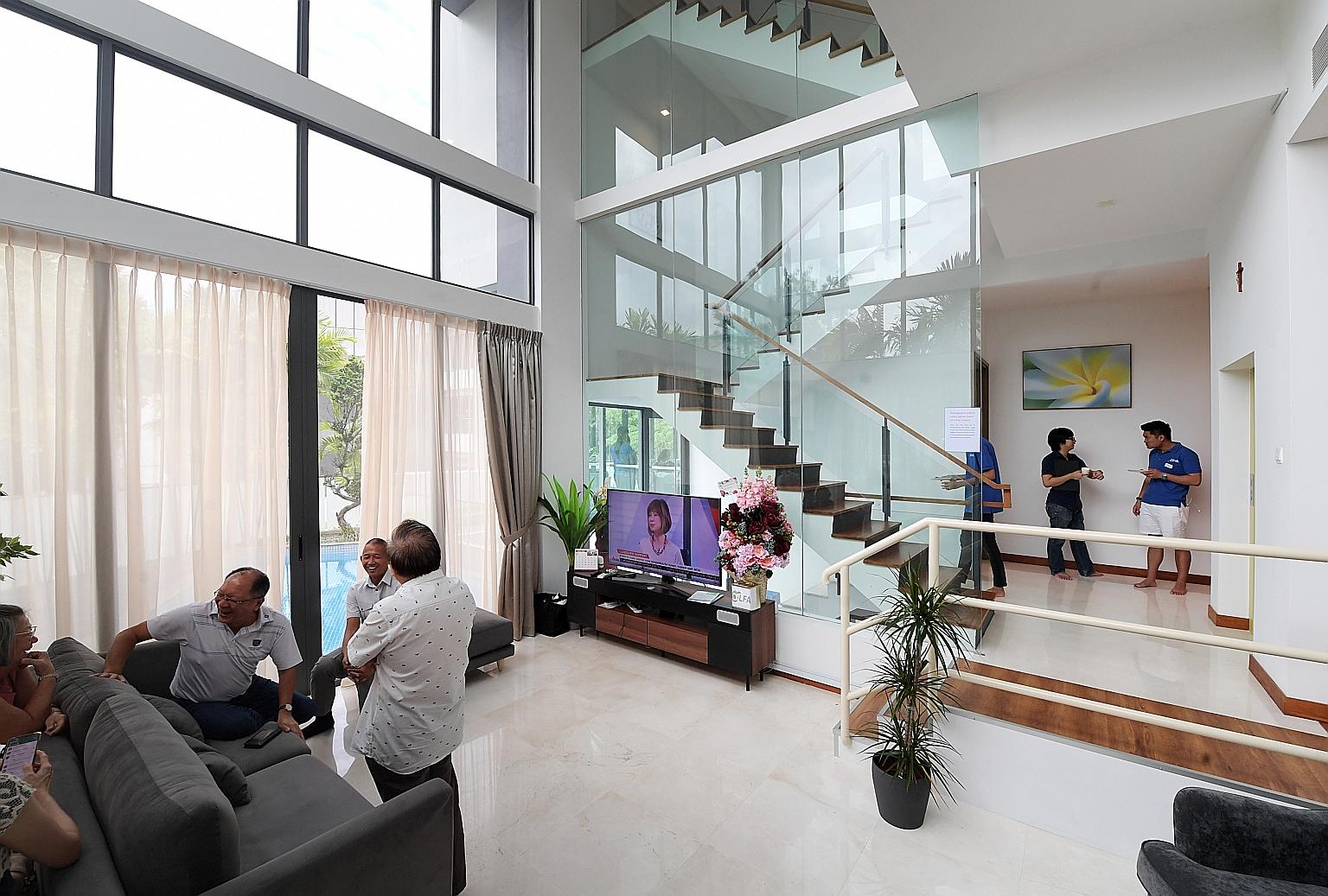 Above: Ms Alice Soh, with caregiver Thae War Soe, 31, visiting St Bernadette's Sembawang facility yesterday. She is a resident at the group's Adam Road facility. Left: The Sembawang facility's metal-and-glass construction makes the four-storey, 5,000