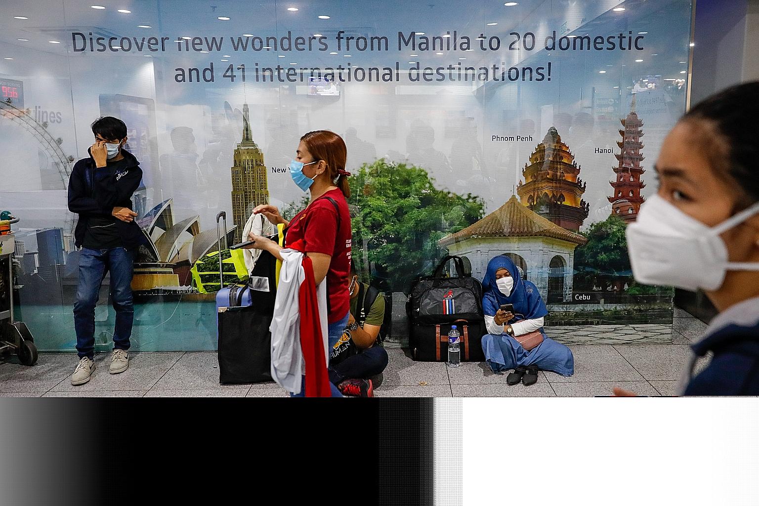 People waiting to buy air tickets from the Cebu Pacific counter at Ninoy Aquino International Airport last Friday, the day after President Rodrigo Duterte announced a month-long lockdown of Metro Manila, starting today.
