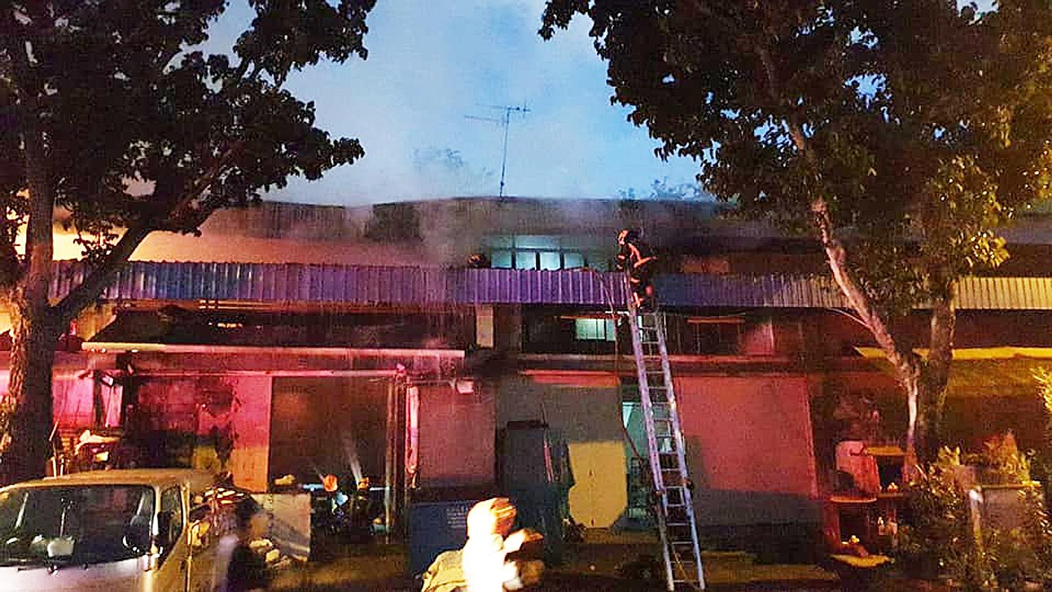 The Singapore Civil Defence Force used four handheld jets and an aerial water monitor to bring the fire at a warehouse in Eunos under control early yesterday. PHOTO: SINGAPORE CIVIL DEFENCE FORCE
