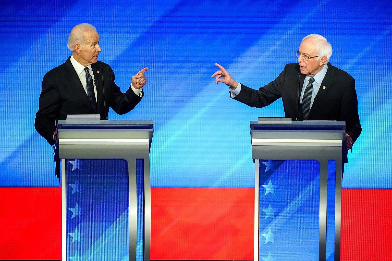 Former US vice-president Joe Biden (far left) and Senator Bernie Sanders at a Democratic presidential debate last month. Their debate today will take place in a Washington, DC studio with no audience, to limit possible exposure to the virus, in a sig
