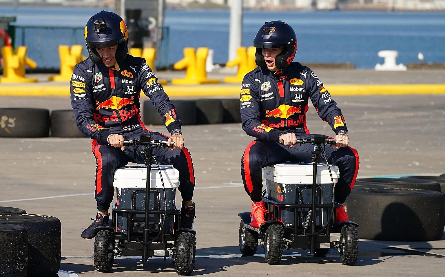 Red Bull driver Max Verstappen (right) and teammate Alexander Albon riding on a motorised cooler at a sponsor's event in Melbourne before the Australian Grand Prix was cancelled.