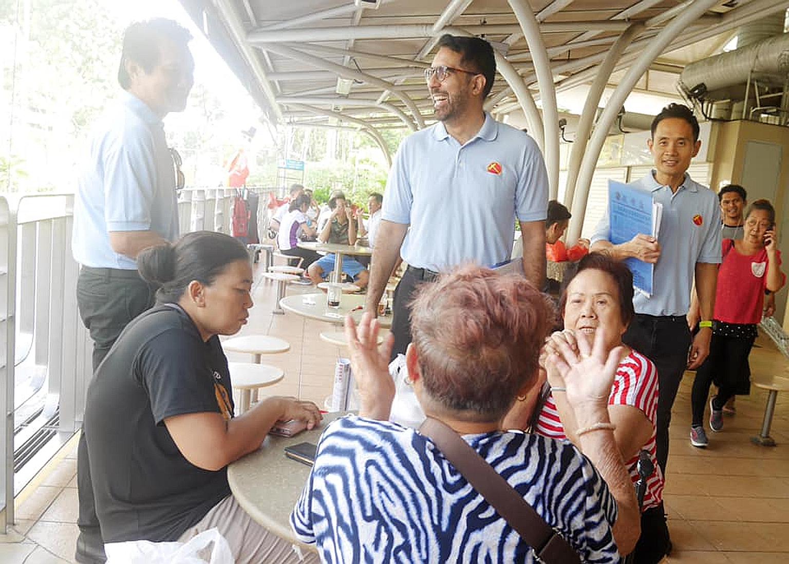 Workers' Party chief Pritam Singh (centre) and member Kenneth Foo (right) at the Eunos division of the WP-held Aljunied GRC earlier this month.