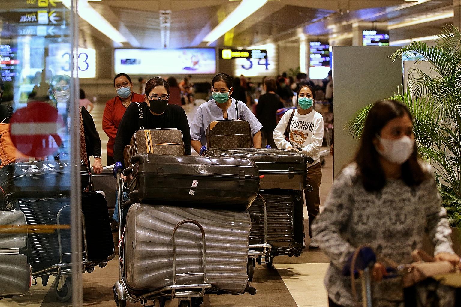 Indonesian travellers arriving at Changi Airport from Jakarta yesterday. Some said they had rushed to book the next flight to Singapore following the announcement on Sunday that Asean nationals will have to obtain the approval of the Ministry of Heal