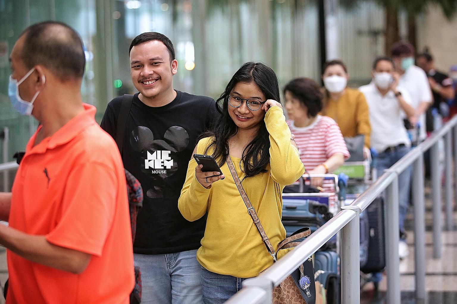 Ms Nadine at Changi Airport yesterday with her husband, Mr Rama, who was there to pick her up. The 25-year-old Indonesian jumped on a flight to Singapore to visit her husband, who has been training to be a pilot here since last month, before the new