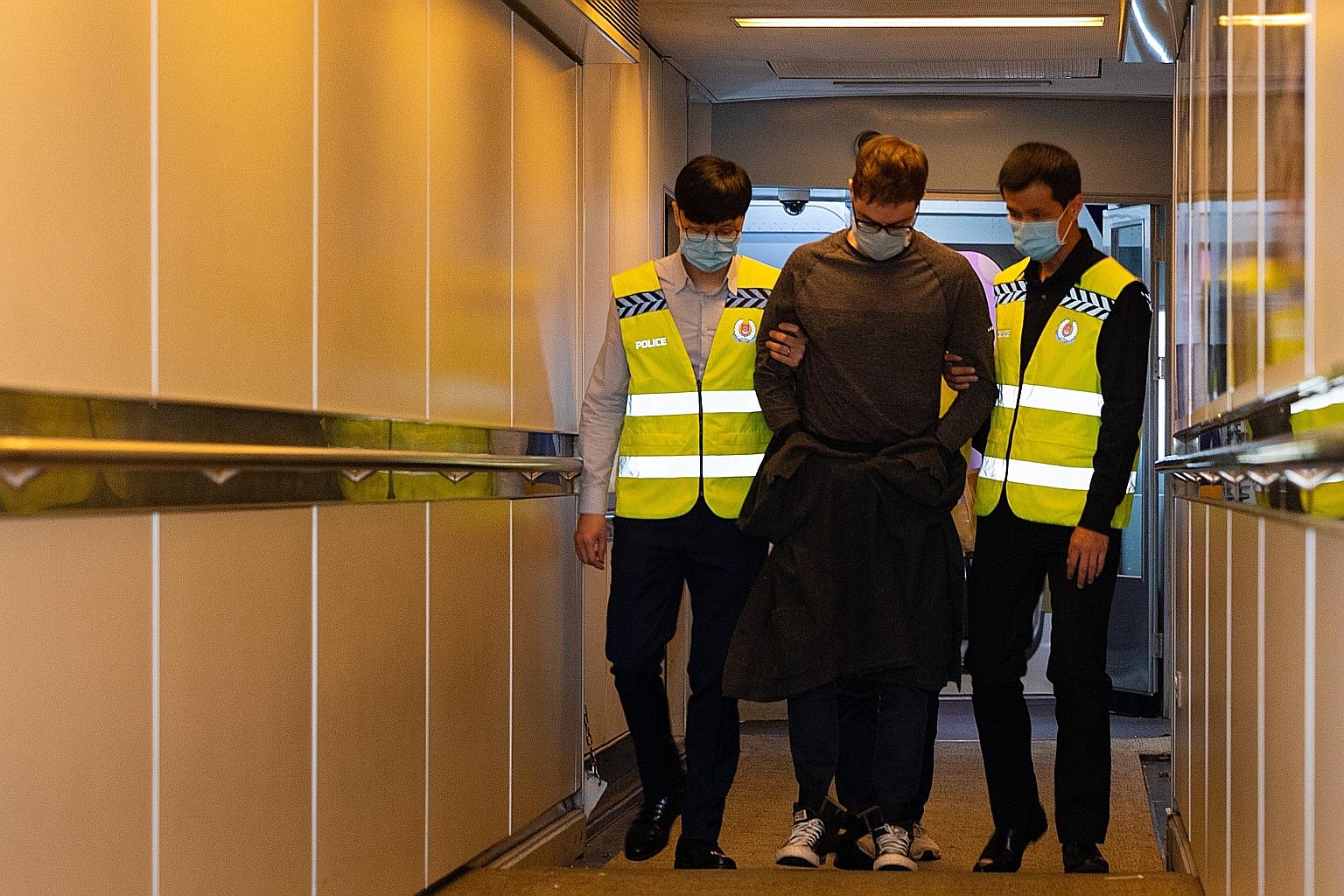 Canadian David James Roach, the suspect in a 2016 robbery of a Standard Chartered Bank branch in Holland Village, arriving in Singapore yesterday in the custody of the Singapore Police Force after he was extradited from Britain. He has been charged w