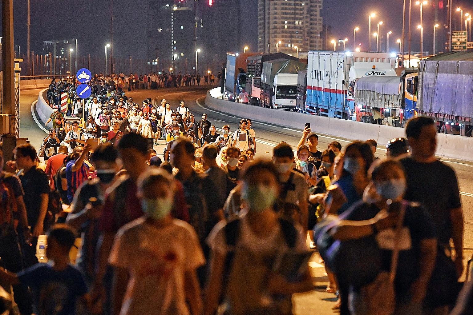 People walking across the Causeway from Malaysia towards Woodlands Checkpoint shortly before 10pm yesterday. Malaysians are barred from travelling abroad from today till March 31. Singapore companies affected by the travel restrictions will get help