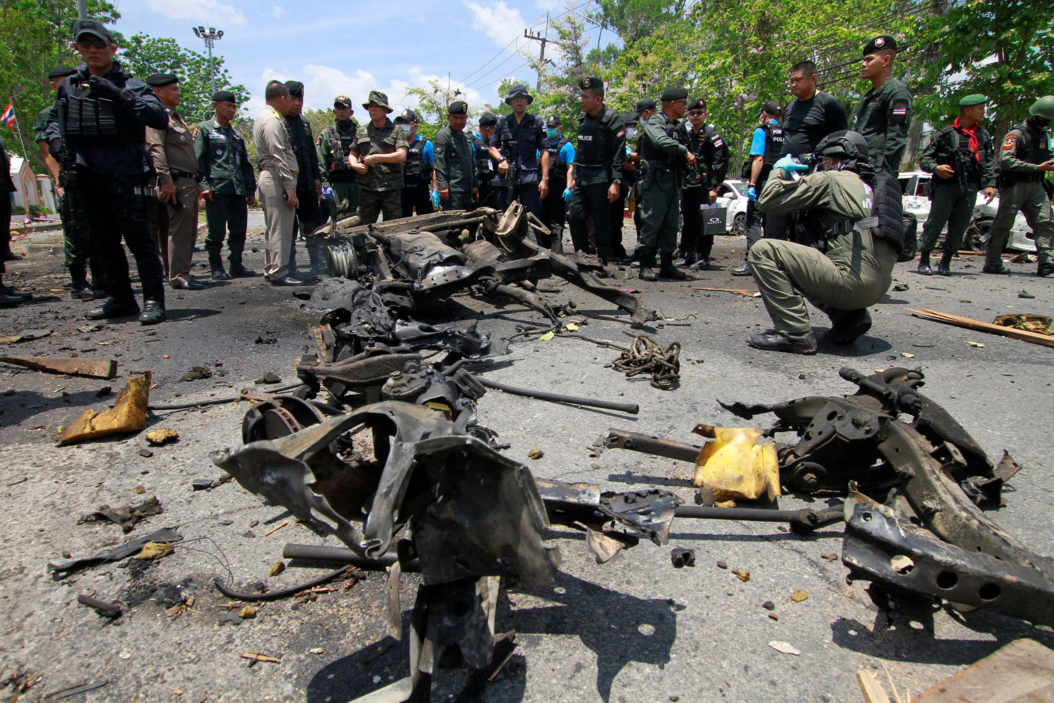 Security personnel at the site of a car bomb which exploded in front of the Thai government's Southern Border Provinces Administrative Centre in Yala yesterday. It was one of two bombs that went off in the area. There was no immediate claim of respon