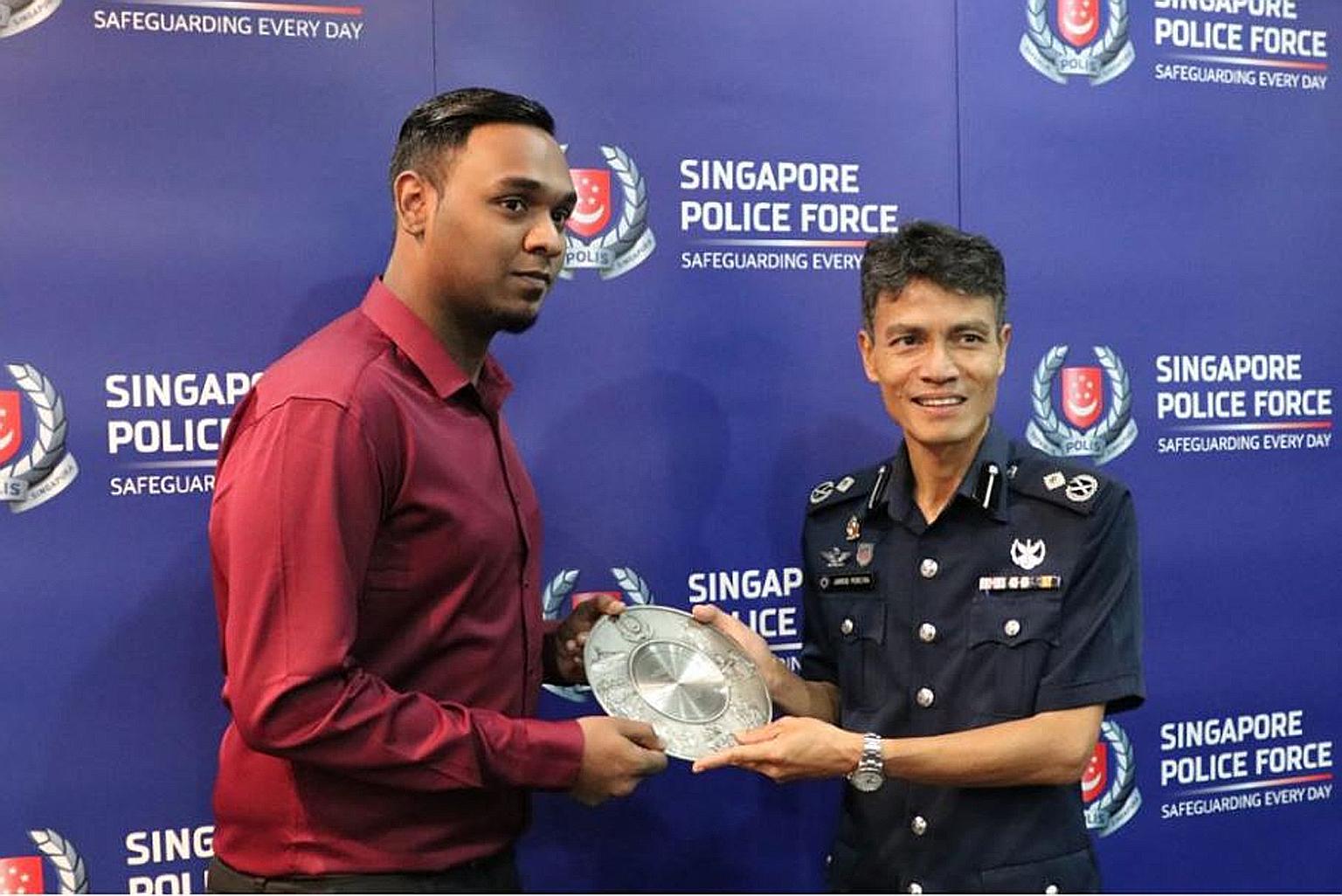 Mr Reshi Kumar Thenarasu being presented with the Public Spiritedness Award yesterday by Assistant Commissioner Jarrod Pereira, commander of the Clementi Police Division, yesterday.