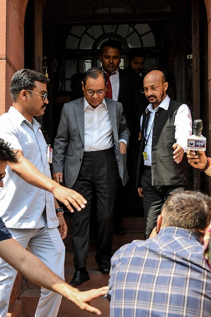 India's former Chief Justice Ranjan Gogoi (centre) leaving Parliament in New Delhi yesterday after taking his oath as a member of the Rajya Sabha or Upper House.