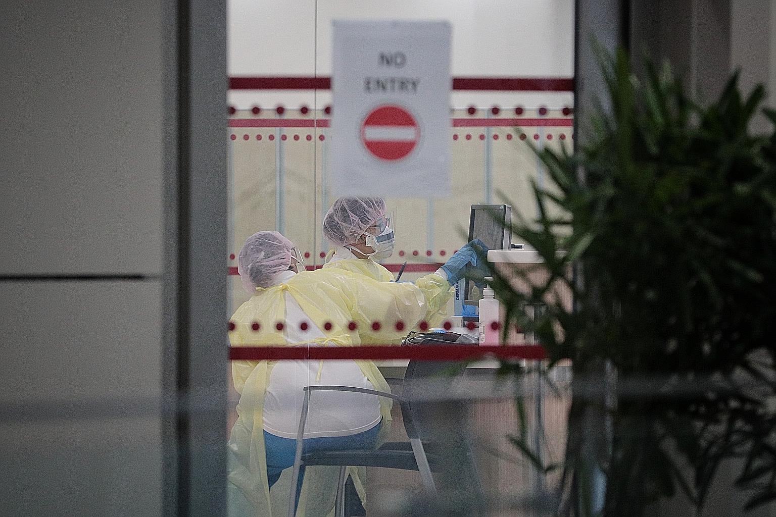 Staff at the National Centre for Infectious Diseases last month. Of Singapore's 159 imported infections, 126 have been reported since March 10. This means, given the total of 345 confirmed coronavirus infections, nearly one in two was imported from s