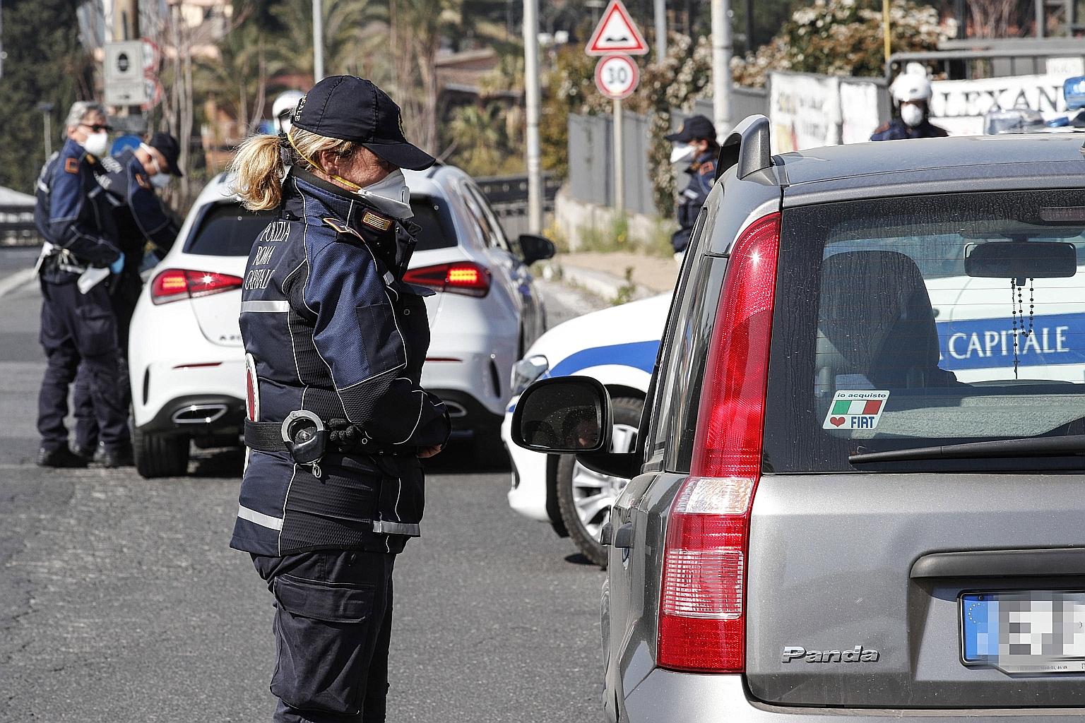 Italian police checking on the movements of motorists during the coronavirus emergency in Rome yesterday. The pandemic has killed almost 3,000 people and infected more than 35,700 in Italy. PHOTO: EPA-EFE