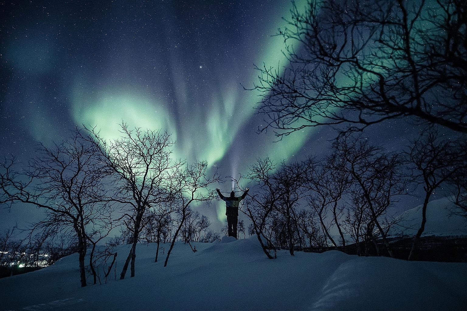 An aurora in the sky in the village of Kilpisjarvi in Finland, which has extended its lead over Denmark and Switzerland even as it once again tops the rankings in the World Happiness Report. Singapore is ranked 31st out of 153.