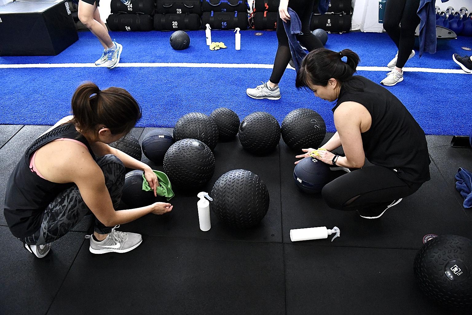 Patrons at F45 Holland Village wiping and sanitising equipment between sets. Gym goers are doing their part to maintain a high standard of hygiene even as outlets implement precautionary steps in view of Covid-19. 