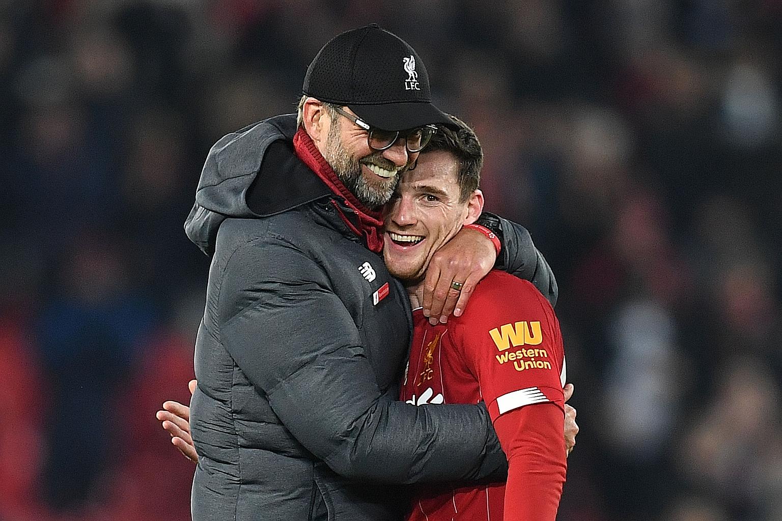 Liverpool manager Jurgen Klopp embraces Reds defender Andrew Robertson after a game against Wolverhampton Wanderers last December. The German's hands-on approach and empathy have won him many fans in the locker room.