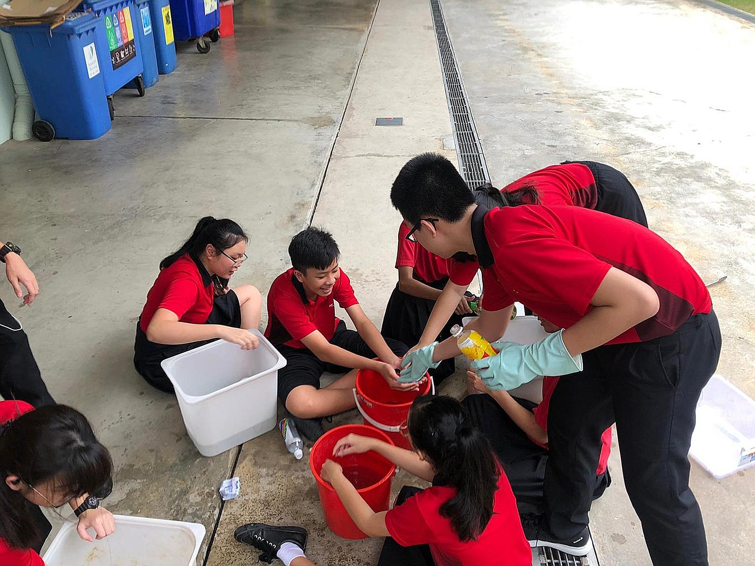 Zhenghua Secondary School student volunteers washing the PET bottles to ensure they are free from contaminants such as food or liquid waste, which would make the entire collection unsuitable for recycling. The inter-school contest was held from Novem