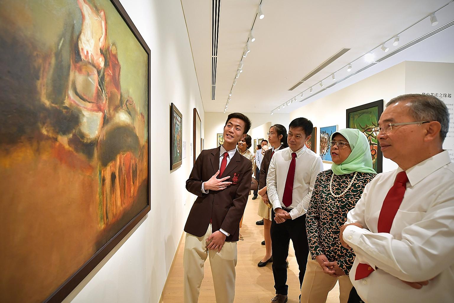 Hwa Chong Institution (HCI) student Hoo Hoi Tzer introducing a painting to President Halimah Yacob, Mr Jonathan Lee (right), chairman of the school's board of directors, and Dr Lim Wee Kiak, chairman of the school's board of governors, at Kuo Chuan C