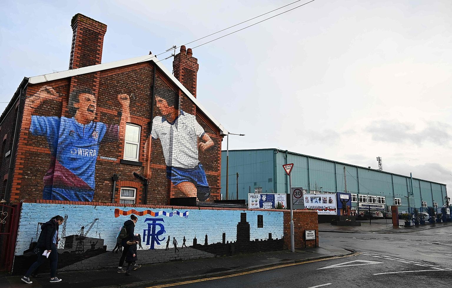 Pedestrians walking past Prenton Park, the relatively modest home ground of third-tier League One side Tranmere Rovers. PHOTO: AGENCE FRANCE-PRESSE
