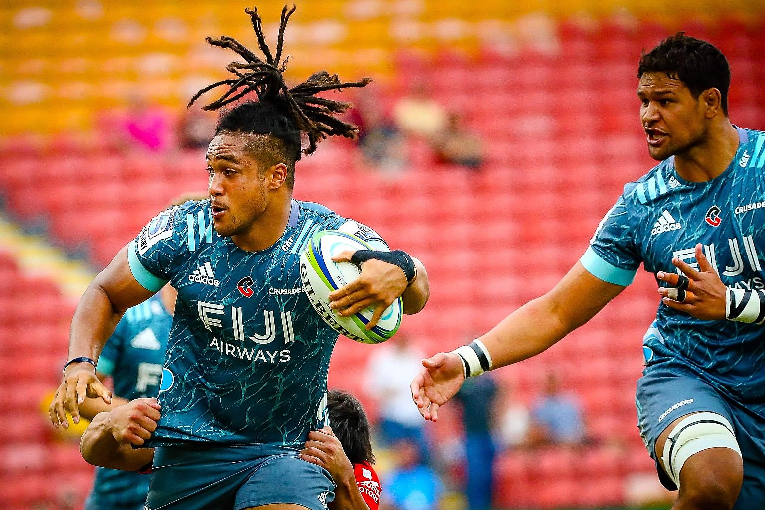 Leicester Faingaanuku (left) of New Zealand's Crusaders is tackled during their Super Rugby match earlier this month against Japan's Sunwolves in Brisbane. The Crusaders are among the teams playing in the domestic league in NZ.