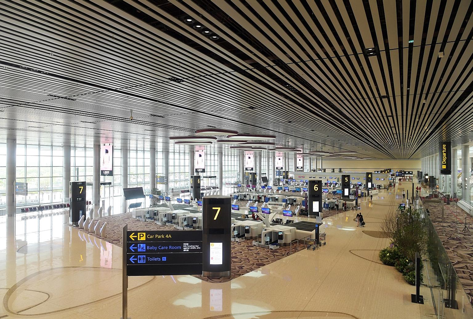 A mostly deserted Changi Airport Terminal 4 last Friday after flight cancellations. Singapore issued a travel advisory last week telling Singaporeans to defer all travel. ST PHOTO: ALPHONSUS CHERN