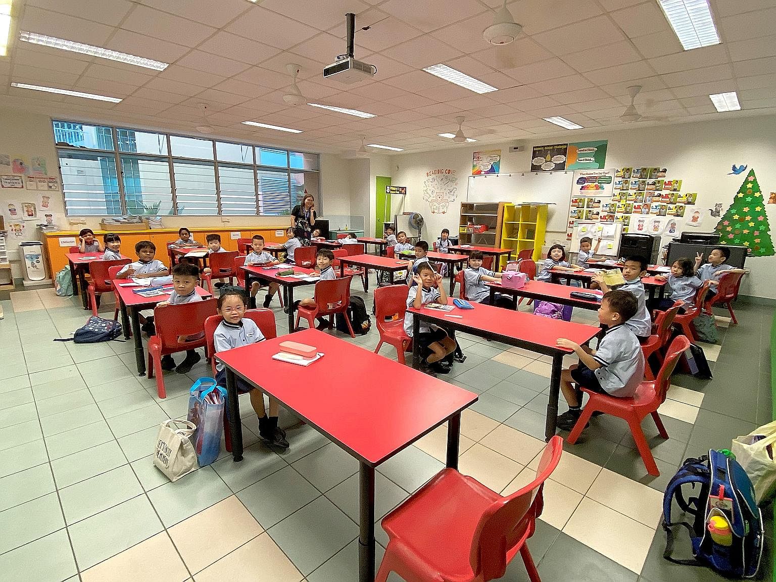 Pupils of Jing Shan Primary returned from the week-long March holidays yesterday to safe distancing measures. In this class, pupils were seated at opposite ends of desks to keep them apart. The Education Ministry has also imposed a leave of absence o