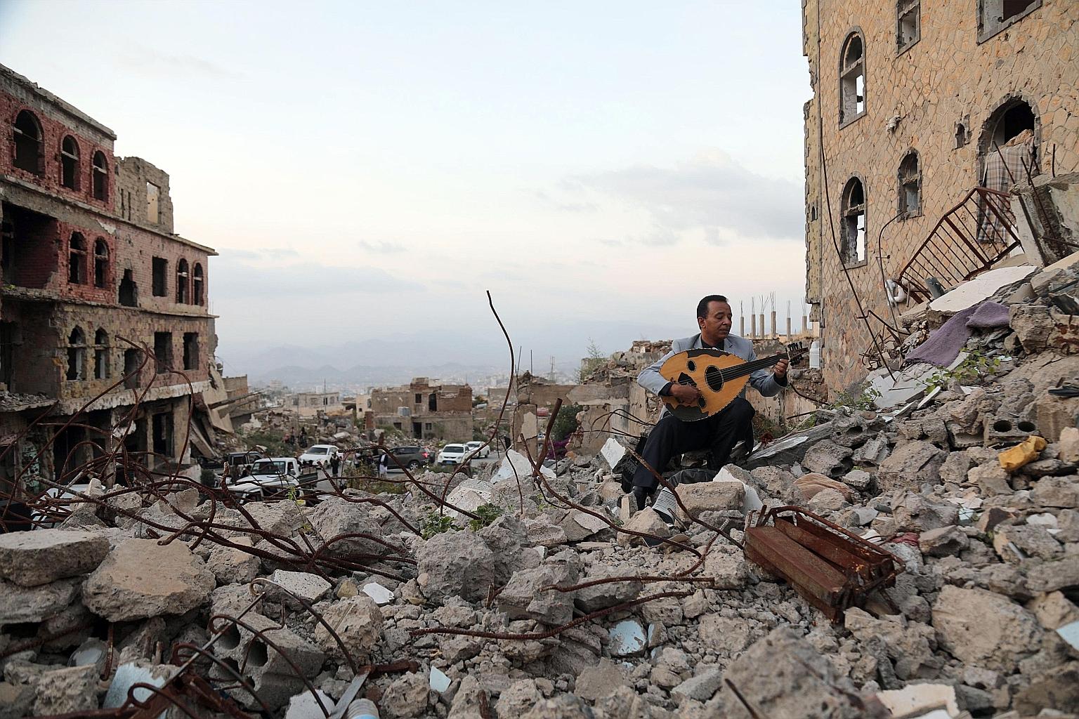 A man playing the oud amid rubble in the Yemeni city of Taez. Five years after launching its military intervention in Yemen, Saudi Arabia has failed to uproot Iran-backed Houthi rebels from their northern strongholds.
