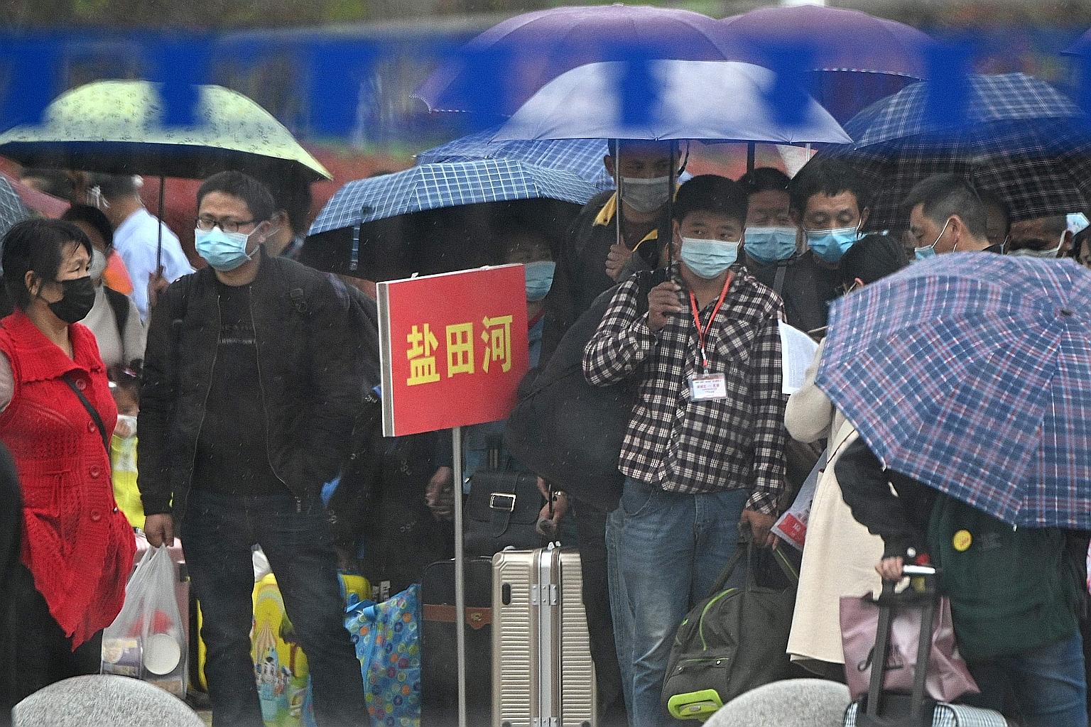 People queueing to buy tickets at the railway station in Macheng, in China's central Hubei province, yesterday. Strict curbs on daily life are finally being lifted, allowing healthy people to head home and see their loved ones after weeks of separati