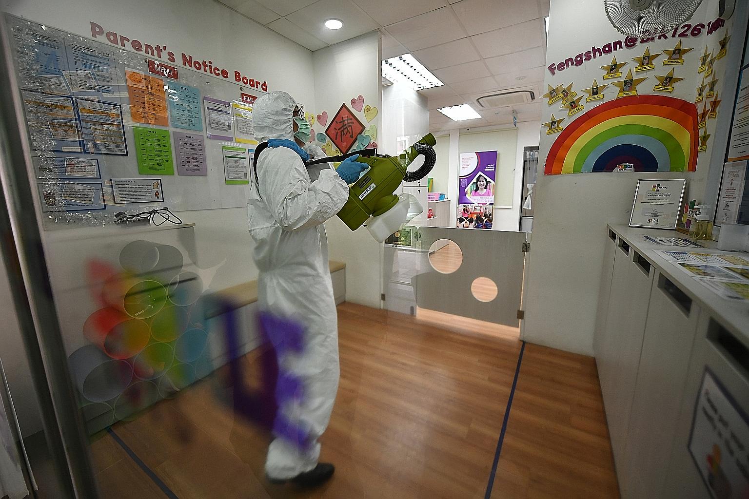An employee from a professional cleaning company engaged by PCF Sparkletots disinfecting the pre-school at Fengshan Block 126 on Tuesday. PCF said it is closing all its centres to "review and reiterate" its precautionary measures with its employees a